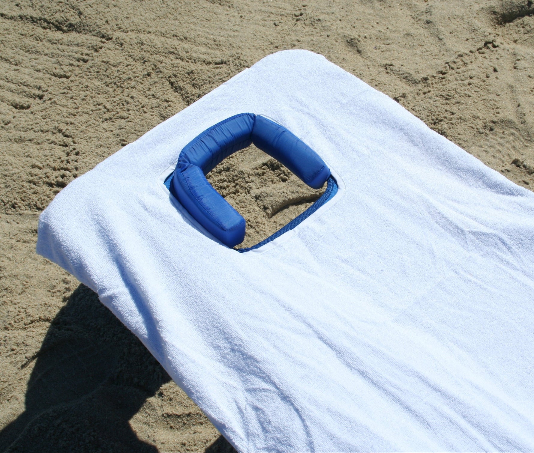 White Ostrich custom fitted towel on the chaise lounge chair, highlighting the custom fitted towel's cutout to match the Ostrich head hole